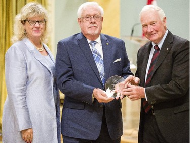 George Stewart of National Defence, center receives the Public Service Award of Excellence for 60 years of service from Janice Charette, clerk of the privy council, left, and David Johnston, Governor General of Canada, right, at Rideau Hall Wednesday September 16, 2015. (Darren Brown/Ottawa Citizen) - Assignment 121627