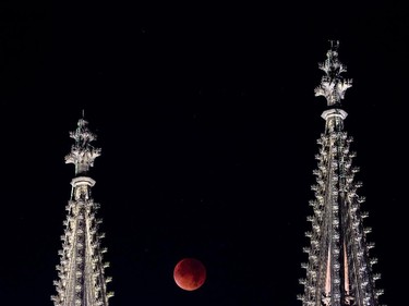 A so-called "blood moon" can be seen between the steeples of the Cologne Cathedral during a total lunar eclipse in Cologne, western Germany, on September 28, 2015. Skygazers were treated to a rare astronomical event when a swollen "supermoon" and lunar eclipse combined for the first time in decades, showing Earth's satellite bathed in blood-red light.