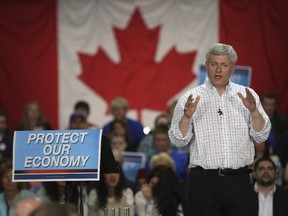 Stephen Harper speaks with Conservative Party supporters at a campaign rally during a stop in Calgary – emphasizing the economy.