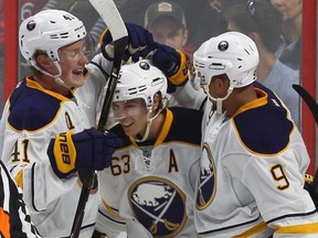 The Buffalo Sabres' Tyler Ennis celebrates his third-period goal with teammates Jack Eichel, left, and Evander Kane, right.