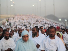 Hundreds of thousands of Muslim pilgrims make their way to cast stones at a pillar symbolizing the stoning of Satan, in a ritual called "Jamarat," the last rite of the annual hajj, on the first day of Eid al-Adha, in Mina near the holy city of Mecca, Saudi Arabia, Thursday, Sept. 24, 2015.