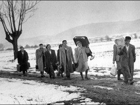 Hungarian refugees fleeing in November 1956 the Soviet army intervention in their country cross the frontier into Austria. The Red Army, stationed in Hungary under the 1947 peace treaty, attacked and seized 12 November 1956 the Hungarian capital and crushed the anti-communist uprising.