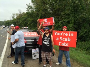 About 100 airport taxis protesting along the airport parkway.