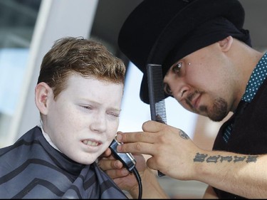 Jonathan Pitre gets a cut by House of Barons senior barber, James Fowler, during a promotional event in the Byward Market Thursday September 10, 2015 for Opera Lyra's Figaro, the Barber of Seville, which runs from Saturday September 26 to Saturday October 3 at the National Arts Centre. (Darren Brown/Ottawa Citizen)