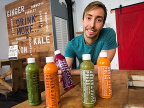 Justin Gauthier of Urban Juice Press with some of his products.  The business used to operate out of crammed commercial kitchen that wasn't open to the public, has now opened a hip retail outlet in HIntonburg, with a new smoothie bar.  Assignment - 121466 Photo taken at 10:18 on September 1. (Wayne Cuddington/ Ottawa Citizen)