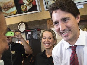 Liberal Leader Justin Trudeau serves customers during a campaign stop at a coffee shop, Tuesday, September 1, 2015 in Gatineau, Que.