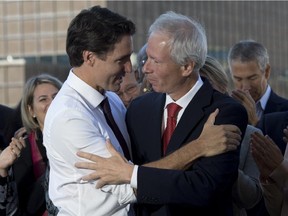 Liberal Leader Justin Trudeau speaks with former leader Stéphane Dion following a campaign stop in Montreal Tuesday.