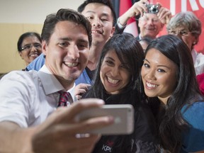 Liberal Leader Justin Trudeau takes a souvenir photo with a group of supporters during a campaign event Wednesday, September 30, 2015 in Surrey, B.C.