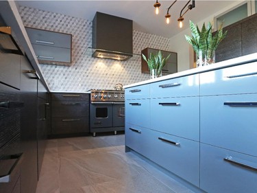 The cupboards, provided by Potvin Kitchens, combine grey lacquer (island and uppers) with rift oak perimeter cabinets in a silver and charcoal finish and the walnut of the island extension and upper frames. With all those finishes, Correy knew the quartz counters had to be plain ’to tame everything else down.’ She then added pattern in the backsplash, a 3D hexagon in marble.