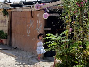 A Syrian refugee child plays at an unofficial refugee camp in the northern Lebanese city of Tripoli, north of the capital Beirut, on Sept. 2, 2015.