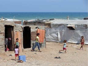 Syrian refugee children play at an unofficial refugee camp in the area of Arida, north of Beirut, on June 15, 2015.