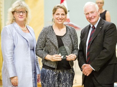 Leila El-Khatib of Public Works and Government Services Canada, center, receives the Public Service Award of Excellence in Youth from Janice Charette, clerk of the privy council, left, and David Johnston, Governor General of Canada, right, at Rideau Hall Wednesday September 16, 2015. (Darren Brown/Ottawa Citizen) - Assignment 121627