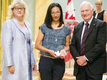 Lesley Ann Facto from National Defence, center, receives the Public Service Award of Excellence in Youth from Janice Charette, clerk of the privy council, left, and David Johnston, Governor General of Canada, right, at Rideau Hall Wednesday September 16, 2015. (Darren Brown/Ottawa Citizen) - Assignment 121627