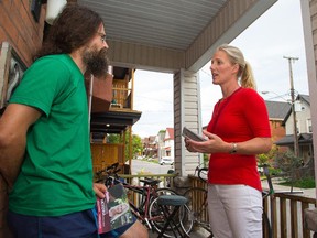Liberal candidate for Ottawa Centre, Catherine McKenna chats with Francesco Palozzi on his doorstep while she does a bit of canvassing on Flora St in the riding she hopes to win on Oct. 19.