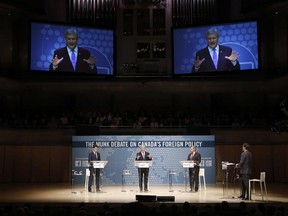 Liberal Leader Justin Trudeau, left to right, Conservative Leader and Prime Minister Stephen Harper and New Democratic Party Leader Thomas Mulcair participate in the Munk Debate on Canada's foreign policy in Toronto, on September 28, 2015.