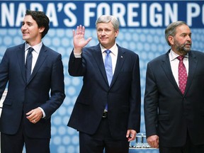 Liberal Leader Justin Trudeau, left to right, Conservative Leader and Prime Minister Stephen Harper and New Democratic Party Leader Thomas Mulcair look to the audience from the stage at the Munk Debate on Canada's foreign policy in Toronto, on Tuesday, September 28, 2015.