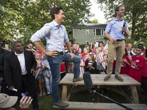 Liberal leader Justin Trudeau stands on a picnic table as he gets introduced by local candidate Matt Decourcey at an event in Fredricton, N.B. Tuesday, Sept, 8, 2015.