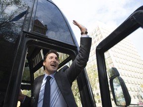 Liberal Leader Justin Trudeau waves from his bus as he leaves the mayor's office in downtown Calgary, Alta. Wednesday, Sept, 16, 2015.