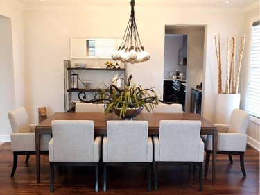 The decor in general was kept ‘a little bit earthy,’ Correy says to help warm up the modern touches. The dining room fixture, also by Nuevo, features 15 half-mirrored globe balls suspended by braided black cables.