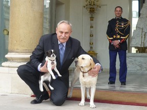 Dr. Francois Lubrina on the steps of the Palais de l'Élysée in Paris with the presidential labrador (born in Canada) Clara Sarkozy and Dumbledore Sarkozy.