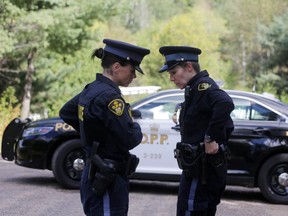 OPP officers guard the scene of one of three slayings on Sept. 23.
