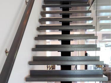 The modern staircase with open risers, steel beam support and glass wall divider make it immediately apparent that this home offers a contemporary design.