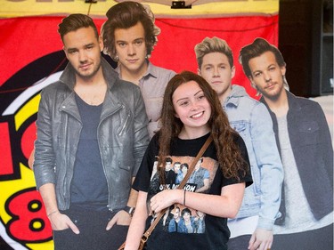 Marye Lafleche poses with cardboard cutouts of the band One Direction prior to the pop group taking to the stage at Canadian Tire Centre on Tuesday night.