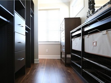 The master suite dressing area is tucked behind the bed and can be accessed from either side. Windows set high in the wall bring in lots of natural light while maintaining privacy.