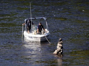MRC des Collines police boat searches the Gatineau River in Wakefield Friday, Sept. 4, 2015.