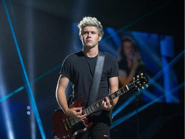 Niall Horan plays guitar as the band One Direction takes to the stage at Canadian Tire Centre on Tuesday night.