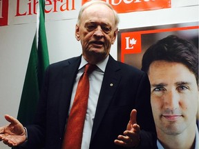 Former prime minister  Jean Chrétien stands  in front of a Trudeau poster in Ottawa on Saturday, Sept. 12, 2015 in Ottawa. Chrétien took aim at the NDP, calling its  policy on Quebec 'irresponsible'.