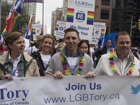Ontario PC Leader Patrick Brown (centre)  and Minister Kellie Leitch walk the route during Toronto's Pride Parade on Sunday June 28, 2015.