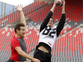 Ottawa Citizen reporter, Tom Hall, challenges Ottawa Redblacks WR, Greg Ellingson for the ball after practice at TD Place Friday August 21, 2015. (Darren Brown/Ottawa Citizen)