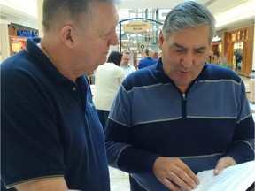 Ottawa Coun. Bob Monette, left, with constituent Michel Villeneuve at a public budget consultation at the Place d'Orléans on Saturday, Sept. 26.