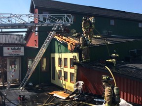 Ottawa firefighters at the scene of a roof fire at Takaki automotive on Breezehill Avenue.