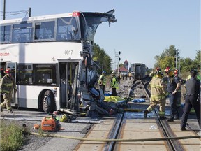 The front of the bus was barely distinguishable while firefighters and police searched at the scene of a horrific crash between an OC Transpo double decker bus and a VIA train near the Fallowfield station in Barrhaven.