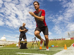 Ottawa Redblacks' head of human performance, Kyle Thorne, left, times Ottawa Citizen reporter, Tom Hall, as he completes an Ottawa Redblacks fitness test at TD Place.