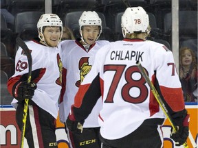 Ottawa Senators forward Max McCormick (69) celebrates with Francis Perron after a goal against Montreal in London, Ont., on Sunday, Sept. 13, 2015.