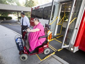 ParaTranso user, Ginette Michel, gets dropped off at her home by Cesar Calderon, driver of one of the new accessible buses.