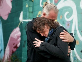 Robert Van Vlaenderen consoles his partner, Natalie Robinson, at a community drop-in session in Killaloe on Wednesday.