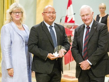 Ron Lyen of Natural Resources Canada receives the Public Service Award of Excellence for Excellence in Policy on behalf of the team responsible for the Extractive Sector Transparency Measures Act from Janice Charette, clerk of the privy council, left, and David Johnston, Governor General of Canada, right, at Rideau Hall Wednesday September 16, 2015. (Darren Brown/Ottawa Citizen) - Assignment 121627