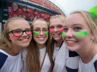 Savannah Hall, 16, (from left) Samantha Nicholls, 16, Vanessa Gervais, 16, and Katie Kissick, 16, with their faces painted and the name of their favourite band member on the back of their t-shirts as the band One Direction takes to the stage at Canadian Tire Centre on Tuesday night.