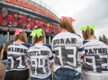 Savannah Hall, 16, (from left) Samantha Nicholls, 16, Vanessa Gervais, 16, and Katie Kissick, 16, with the name of their favourite band member on the back of their t-shirts as the band One Direction takes to the stage at Canadian Tire Centre on Tuesday night.