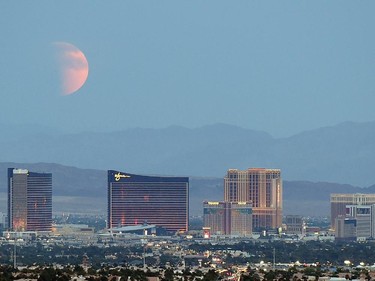 An eclipsed supermoon rises behind the Las Vegas Strip on September 27, 2015 in Las Vegas, Nevada. A supermoon occurs when a full moon coincides with its perigee, which is its closest approach to the Earth. A lunar eclipse and a supermoon won't occur together until 2033.