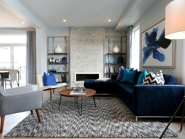 A deep blue sectional and patterned rug set the tone in the Talbot living room, which hints at a throwback to the 1950s.