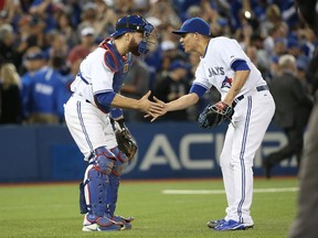 Roberto Osuna #54 of the Toronto Blue Jays celebrates their victory with Russell Martin #55 during MLB game action against the Tampa Bay Rays on September 25, 2015 at Rogers Centre in Toronto, Ontario, Canada.