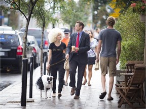 Crystal Macintosh, her dog Raffaella and husband Keith Macintosh stroll along Wellington Street West to promote The Capelli Club, a space specializing in hair and makeup to facilitate local artists and artisans.