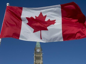 The Canadian Flag flies over the Peace Tower on Parliament Hill on the 50th anniversary of the Canadian Flag in Ottawa on Sunday, Feb. 15, 2015.