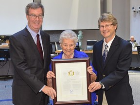 Mayor Jim Watson and Capital Ward Coun. David Chernushenko present the Mayor's City Builder Award to Marie McIntosh.