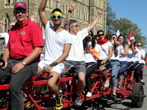 Thirty public servants (including Deputy Minister of Justice, Bill Pentney, third from left, jumped aboard a tandem bike in September 2015.